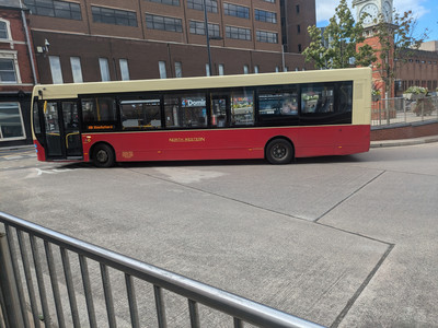 A red and cream bus with the text NORTH WESTERN and a sign indicating it is on route 88 to Knutsford.